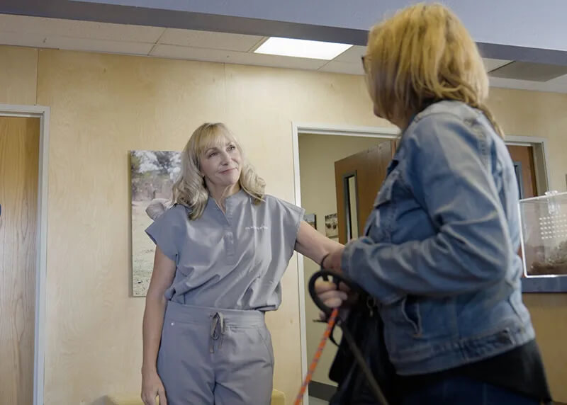 Dr. Stewart talking to a client